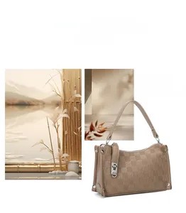 Detail view of brown checkered satchel featuring a silver twist lock and slim handles