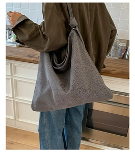 Detailed view of grey suede leopard print tote bag with stylish knotted shoulder strap