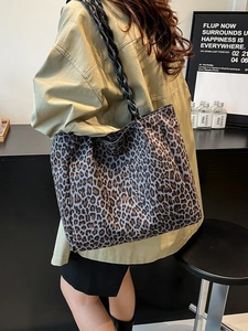 Retro leopard print tote bag with black woven straps shown as a stylish shoulder bag