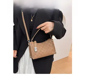 Detailed close-up of retro checkered pattern and silver buckle on a brown shoulder bag