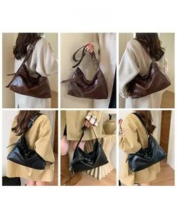 Detail view of large soft leather hobo bag with adjustable eyelet shoulder strap
