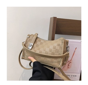 Detail of beige checkered embossed leather pillow bag with silver buckle and metal zipper