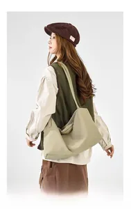 Close-up of khaki drawstring crossbody bag with large capacity and pleated design