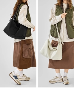 Detailed close-up of large canvas tote bag with adjustable metal eyelet strap design