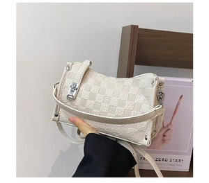 Detailed macro view of the cream checkered pattern leather and silver clasp closure