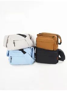 Detail view of water-resistant nylon crossbody bags in beige, tan, blue, and black
