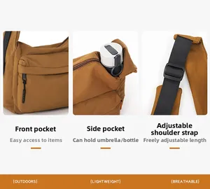 Detail of brown nylon crossbody bag showing side pocket for water bottle and front zipper