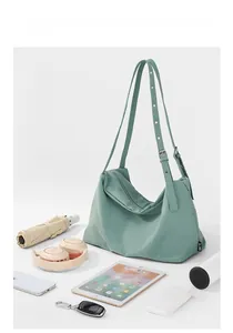 Spacious mint green nylon hobo bag showing capacity for daily essentials and gadgets