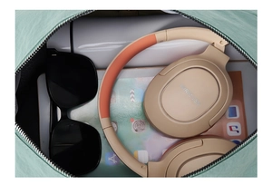 Top view of spacious mint green tote bag showing storage for headphones and tablet