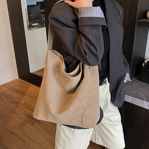 Spacious beige leopard style tote bag shown on model in a retro interior setting