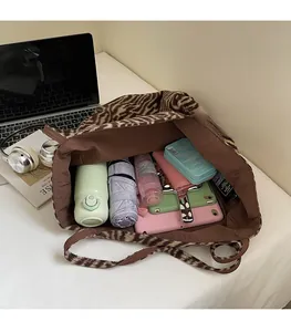 Top view of large animal print tote bag showing spacious interior with personal essentials