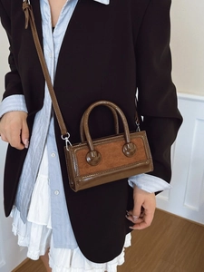 Retro brown leather handbag for women featuring mixed textures and adjustable strap