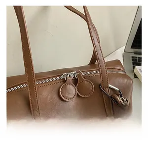 Detail of silver dual zippers and brown oil wax leather on large vintage shoulder bag