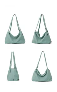 Detailed multi-angle view of mint green nylon hobo bag with eyelet adjustable strap