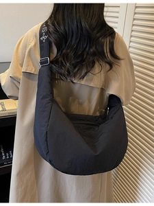 Black quilted crescent crossbody canvas bag with adjustable strap for women in casual style