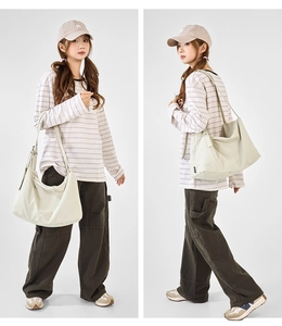 Detail view of cream canvas tote bag showing the textured fabric and adjustable strap
