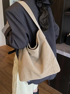 Minimalist beige leather tote bag with large capacity shown on model for daily commuting