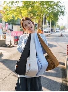 Outdoor shot showing four colors of large-capacity nylon crossbody bags for women