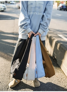 Waterproof nylon shoulder bags in multiple colors with minimalist design and orange label detail
