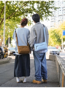 Model wearing a durable nylon crossbody bag with adjustable strap in an outdoor setting