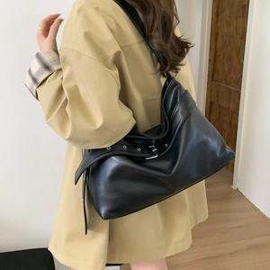 Side view of large black leather hobo bag showing spacious capacity and silver buckle detail