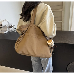 Détail du grand sac cabas en nylon kaki avec cordon de serrage et pendentif café
