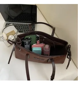 Spacious interior of retro brown pillow bag showing internal pockets and large capacity