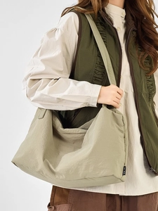 Fashionable minimalist oversized nylon tote bag with drawstring pleated design in olive green