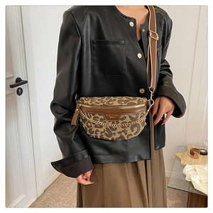 Detail of leopard print crossbody bag with gold chain and leather patchwork texture
