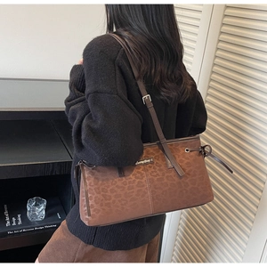 Detailed view of dark brown leopard print shoulder bag with Sunny Day metal tag