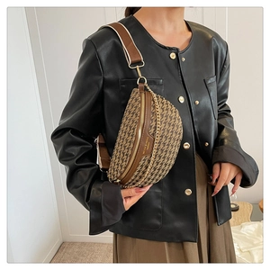 Detail view of woven chest bag featuring geometric textures and adjustable wide strap