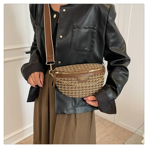 Close-up of a retro patterned crossbody bag with wide strap and gold chain detail
