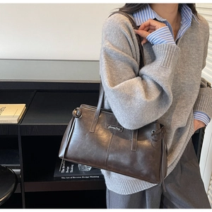 Fashionable dark brown tote bag with Sunny Day label shown on model for daily commute