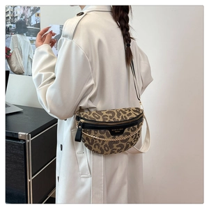Detail of leopard print chest bag with golden chain and adjustable wide shoulder strap