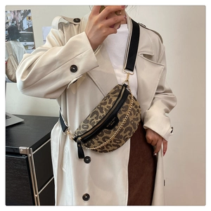 Detail of leopard print chest bag with gold chain and wide nylon strap on model