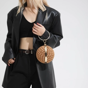 Spherical evening bag with brown polka dot pattern and gold metal ring handle detail