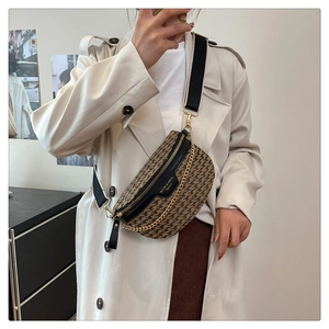 Close-up of retro houndstooth chest bag with black leather trim and metal chain details