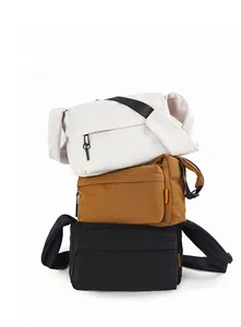 Three nylon messenger bags in beige brown and black showing front zipper and wide straps