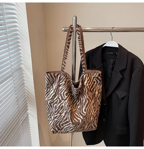 Detail of zebra print tote bag featuring a plush texture and handmade oval label