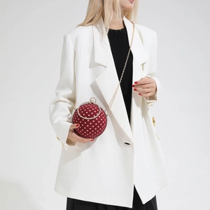 Chic red polka dot spherical evening bag with metal handle and elegant gold chain strap