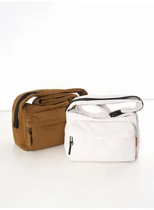 Front view of durable nylon crossbody bags in brown and white with wide zipper pockets