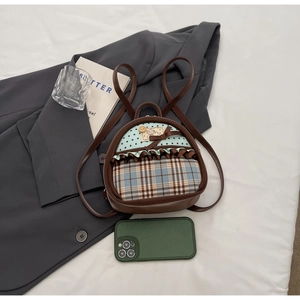Mini bow backpack showing size comparison next to a smartphone with plaid and star details