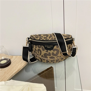 Detailed macro view of the leopard print chest bag with gold chain and wide strap