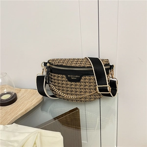 Detail of crossbody chest bag featuring houndstooth pattern and leather trim finish