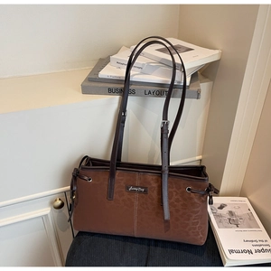 Detail of vintage matte brown tote bag with subtle leopard print and Sunny Day logo