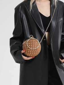Spherical brown polka dot crossbody bag with gold rhinestone ring handle and chain
