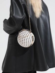 Mini spherical crossbody bag with black polka dots and gold chain handle for women