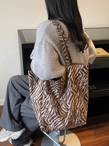 Fashionable zebra print shoulder tote bag with large capacity in a casual lifestyle setting