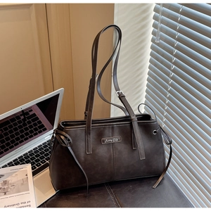 Close-up of vintage brown frosted leather bag with Sunny Day logo and drawstring detail