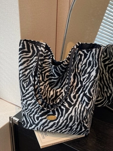 Fashionable zebra print tote bag in textured fabric with spacious open-top design